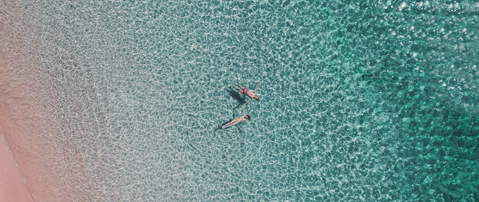 Pink Beach in Komodo with coral reef visible under clear water